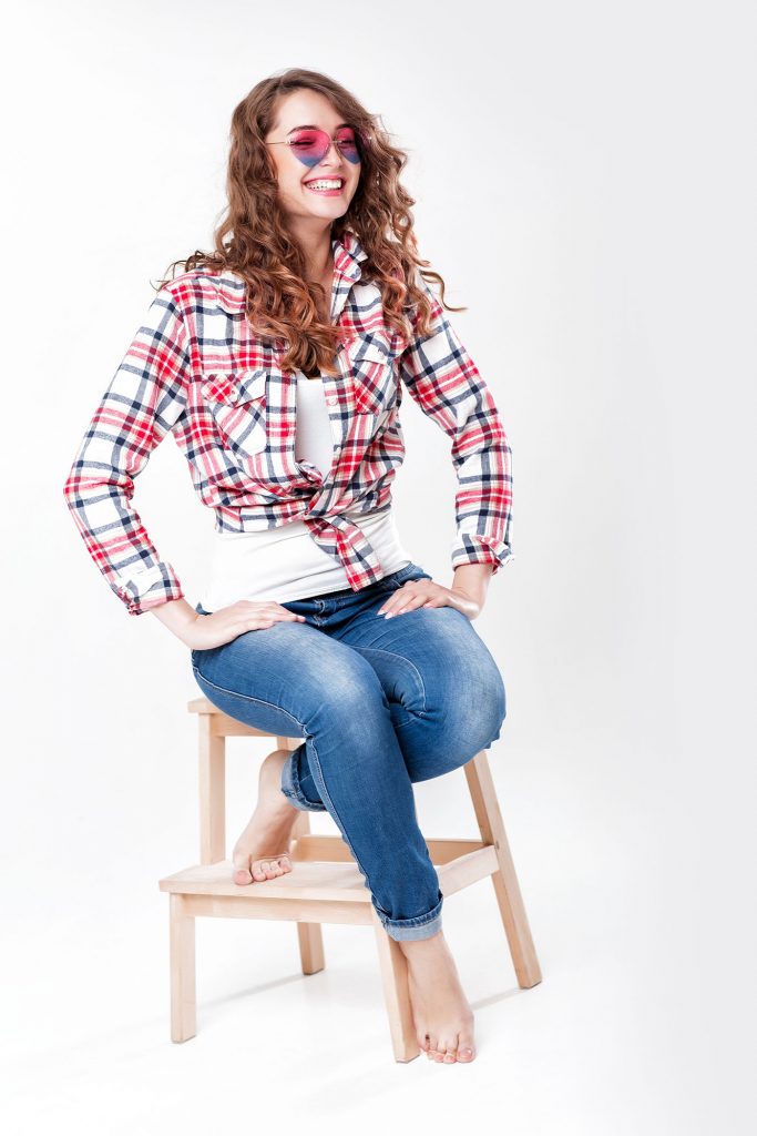 woman in jeans, plaid shirt and sunglasses